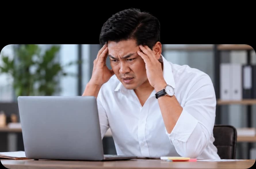 Someone stuck at a laptop, frustrated